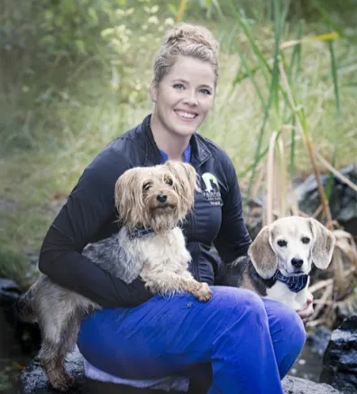 Amanda sitting with two small dogs